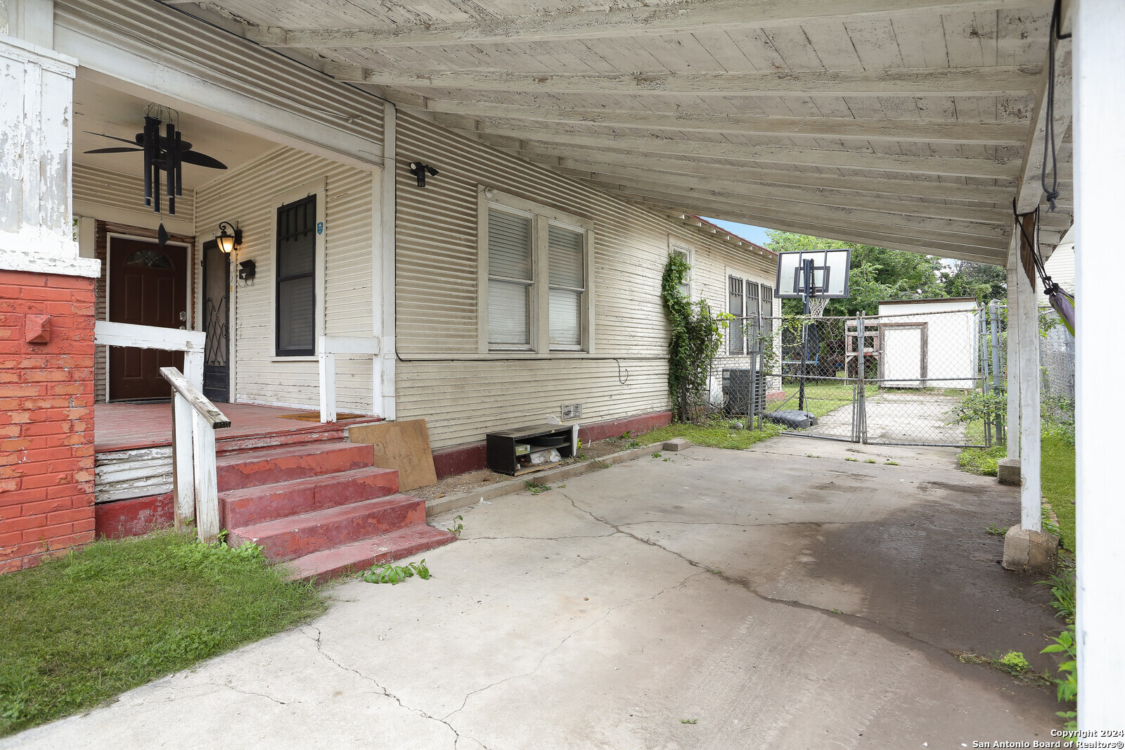 511 Devine Street San Antonio, TX 78210 - Photo 5 of 28 a view of a house with a large window and wooden fence