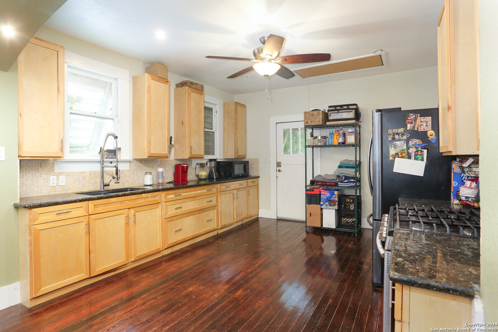 511 Devine Street San Antonio, TX 78210 - Photo 10 of 28 a kitchen view with wooden floor and cabinets