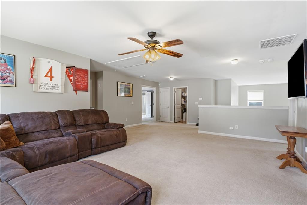 5825 Willow Oak Pass Cumming, GA 30040 - Photo 38 of 55 a living room with furniture and a flat screen tv