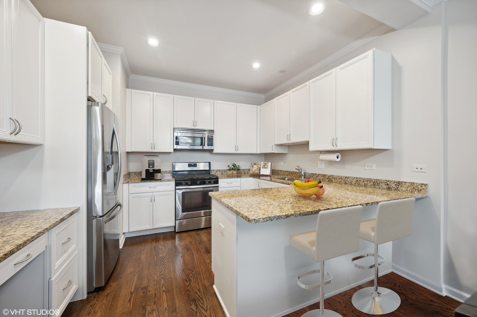 1508 North Sedgwick Street, Unit 5N Chicago, IL 60610 - Photo 5 of 20 a kitchen with a sink a stove a refrigerator and white cabinets