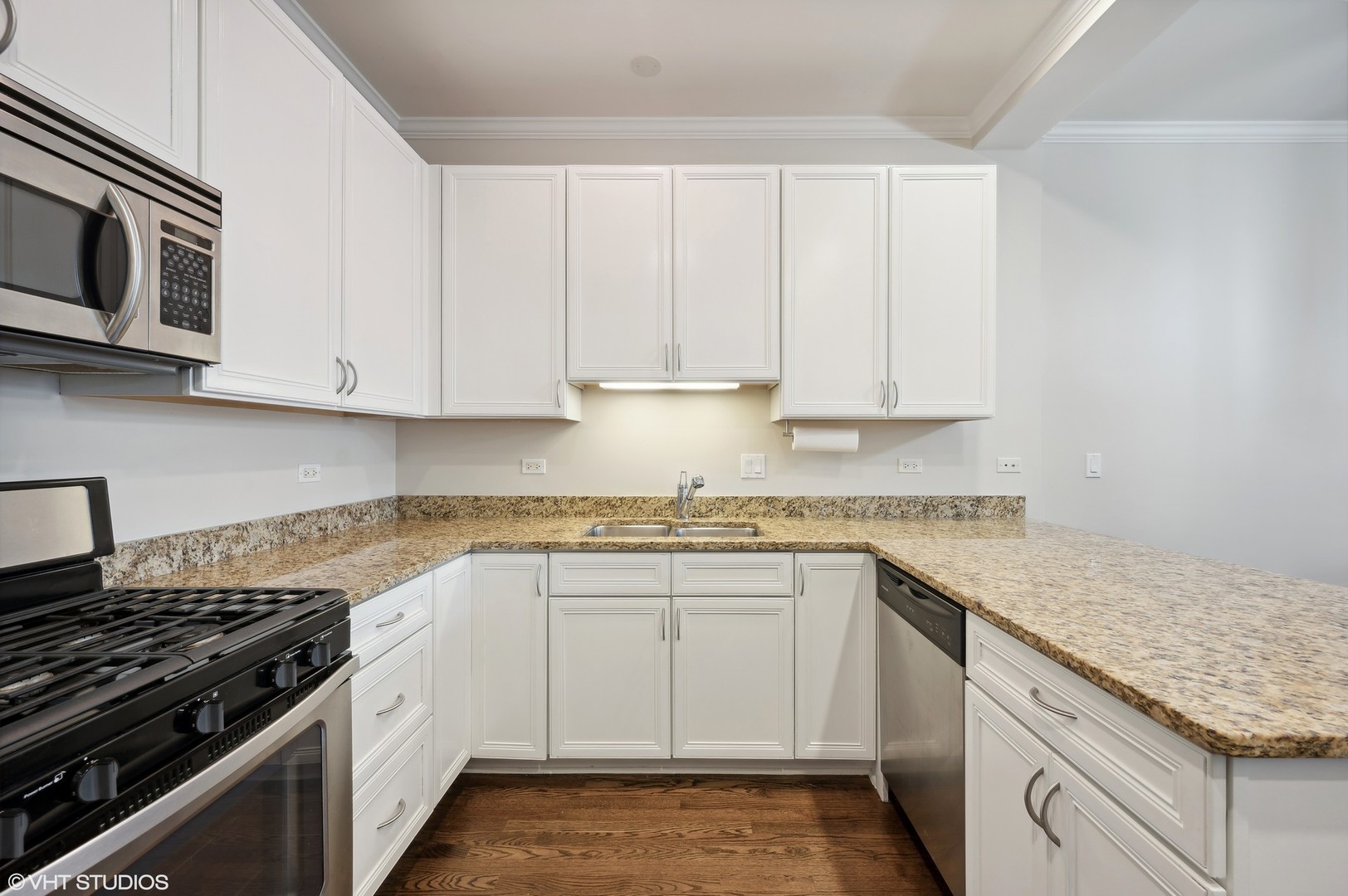 1508 North Sedgwick Street, Unit 5N Chicago, IL 60610 - Photo 6 of 20 a kitchen with stainless steel appliances granite countertop a sink stove and cabinets