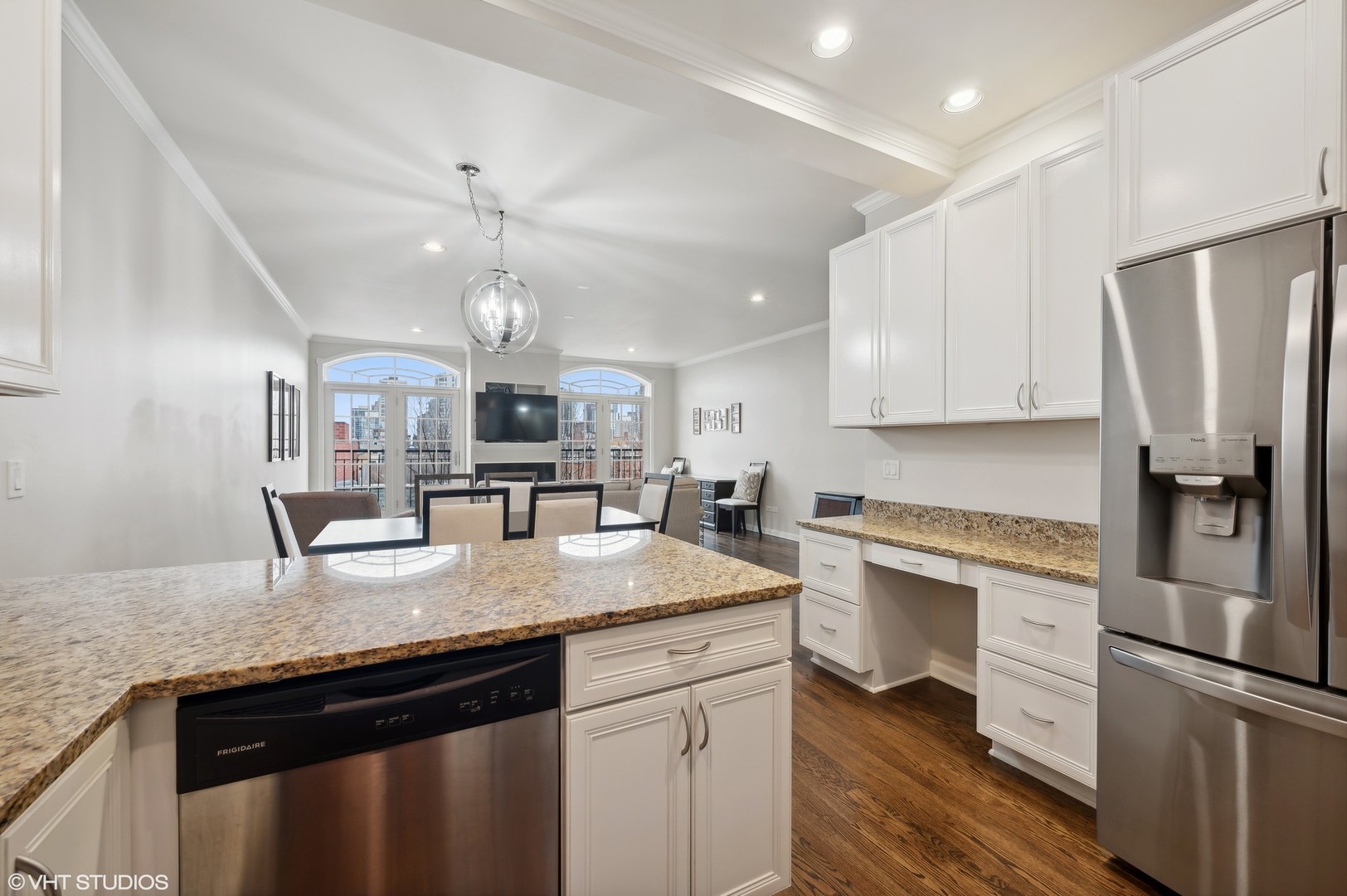 1508 North Sedgwick Street, Unit 5N Chicago, IL 60610 - Photo 7 of 20 a kitchen with a center island wooden floor and stainless steel appliances