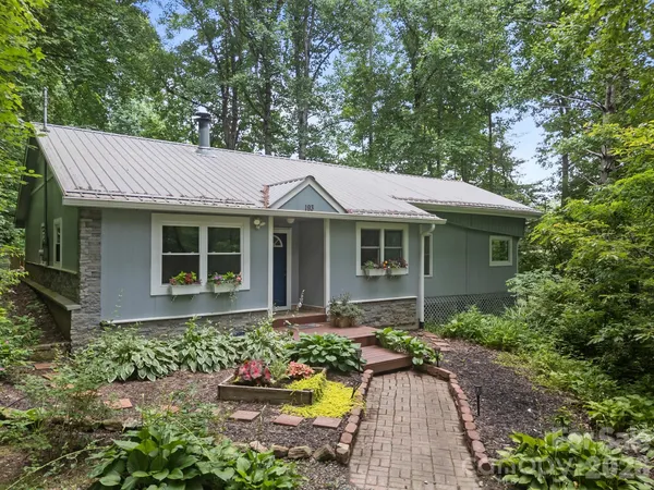 a front view of a house with yard outdoor seating and green space