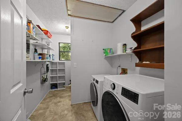 a bathroom with a granite countertop sink toilet and mirror