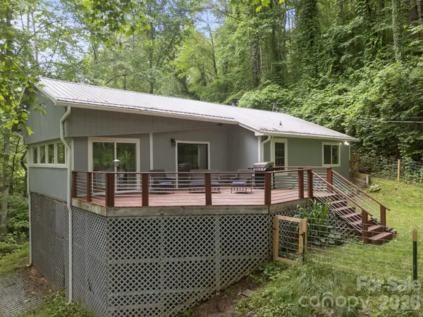 a view of a house with a bed and a deck