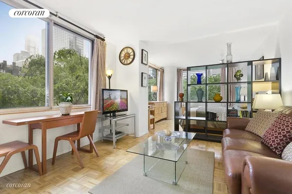 a work room with furniture and a floor to ceiling window
