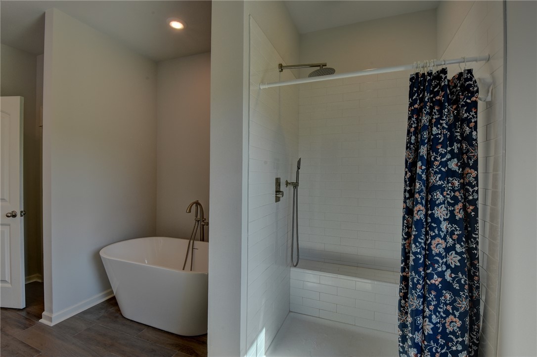 220 Clinkscales Road Anderson, SC 29624 - Photo 11 of 33 A deep soaking tub and a tiled walk-in shower offer a spa-like daily retreat.