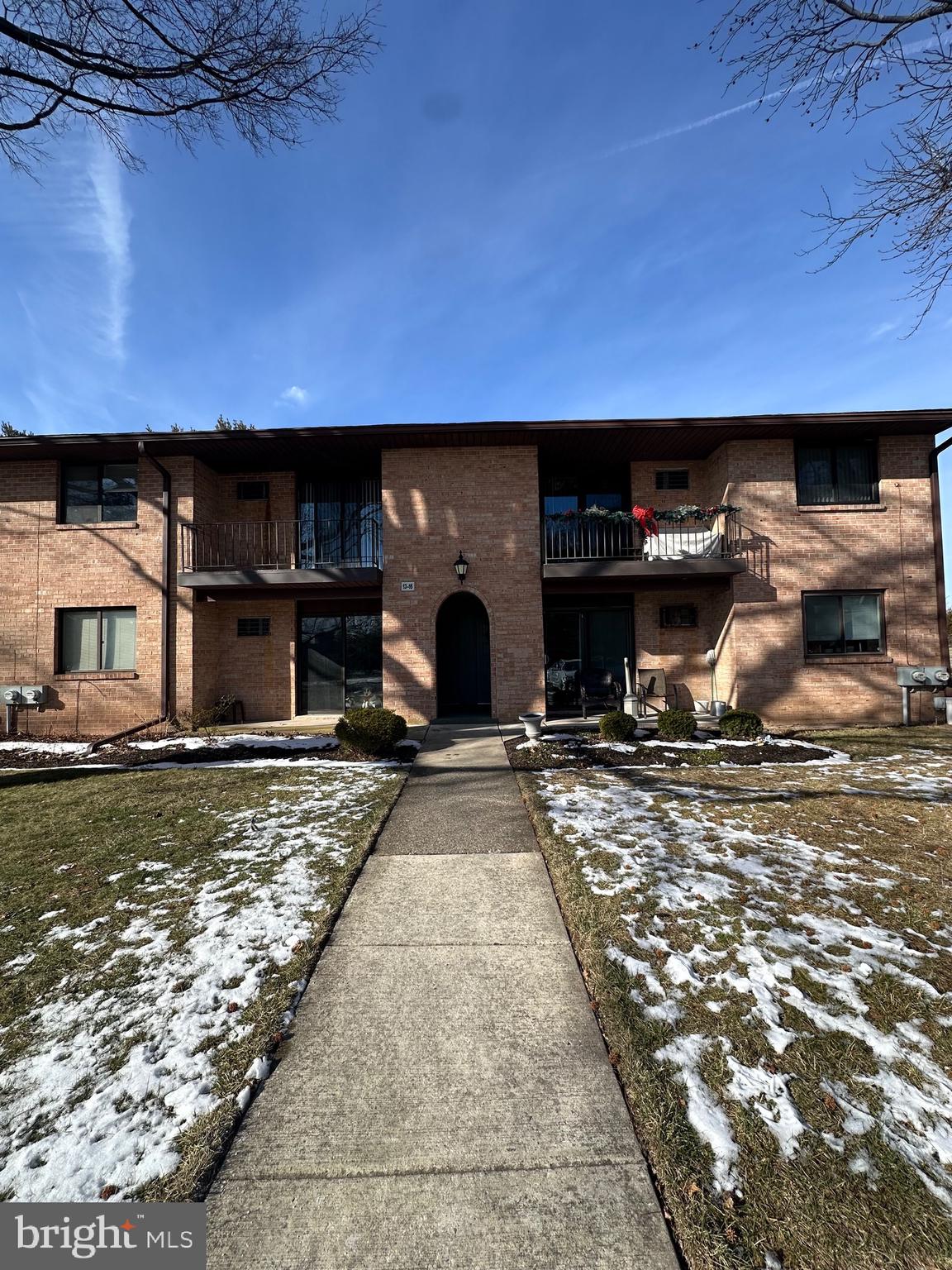 a view of a backyard with a table and chairs under an umbrella