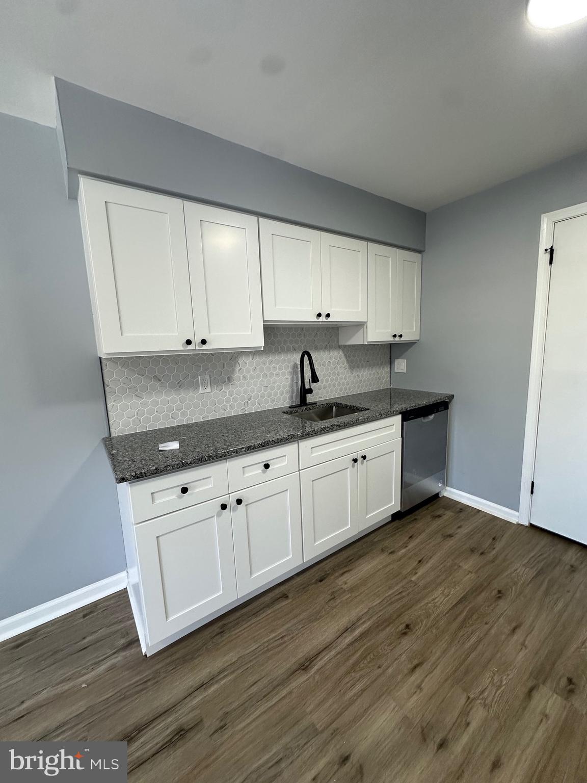 612 North Shady Retreat Road, Unit 14 Doylestown, PA 18901 - Photo 11 of 17 a kitchen with granite countertop white cabinets and a sink