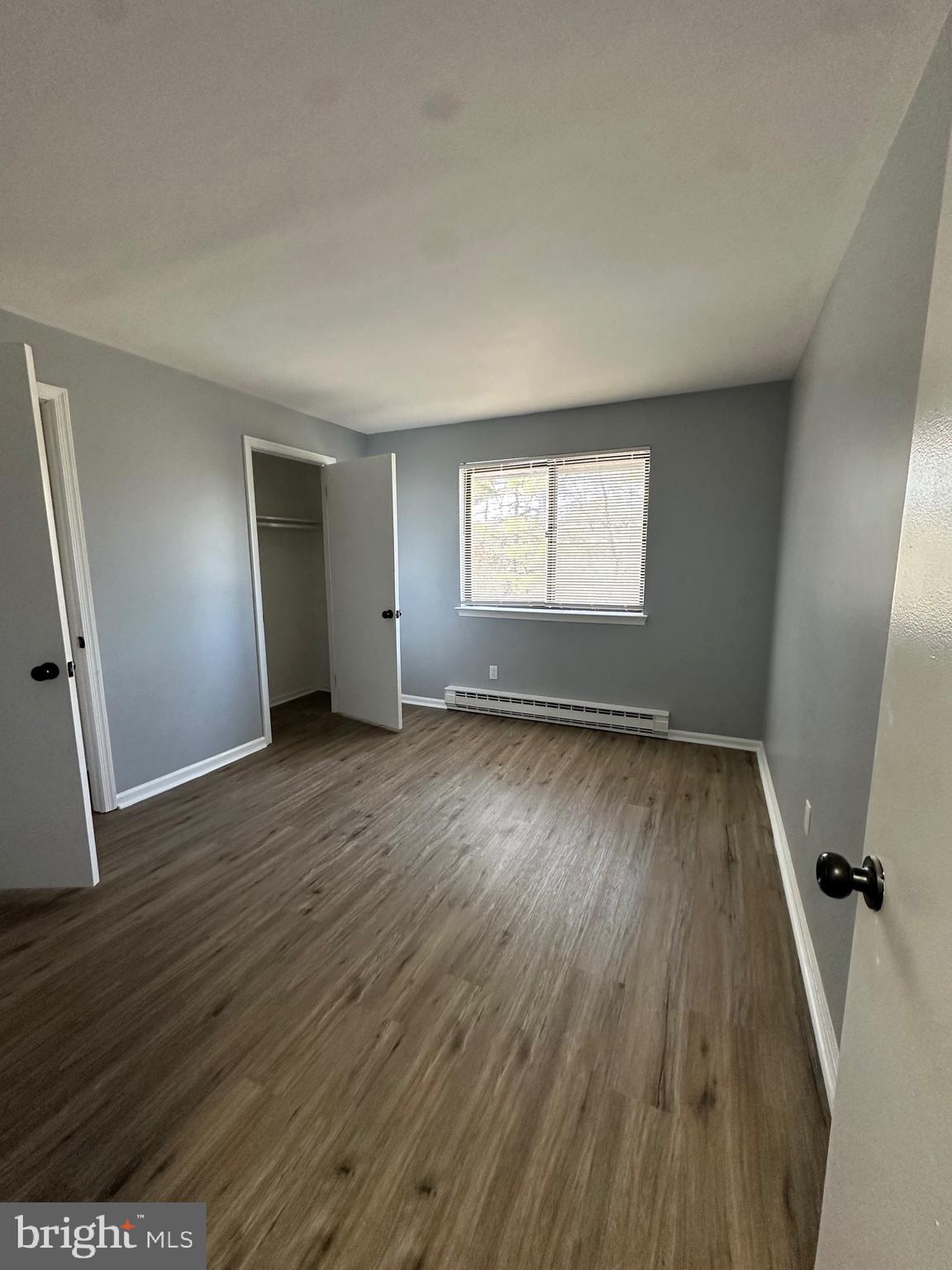 612 North Shady Retreat Road, Unit 14 Doylestown, PA 18901 - Photo 6 of 17 an empty room with wooden floor and windows