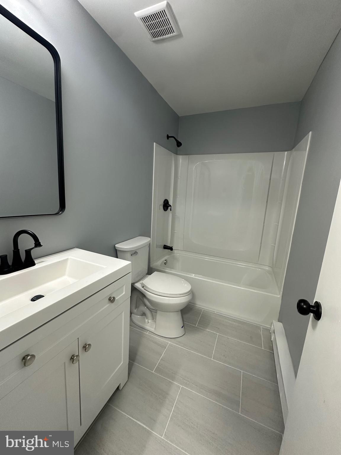 612 North Shady Retreat Road, Unit 14 Doylestown, PA 18901 - Photo 7 of 17 a bathroom with a toilet sink and mirror