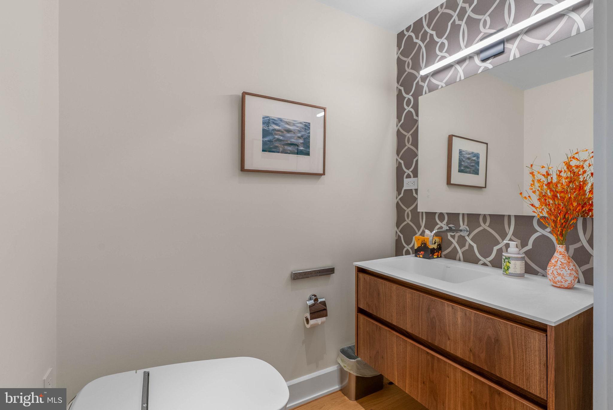 254 South 3rd Street Philadelphia, PA 19106 - Photo 32 of 73 a bathroom with a toilet sink and mirror