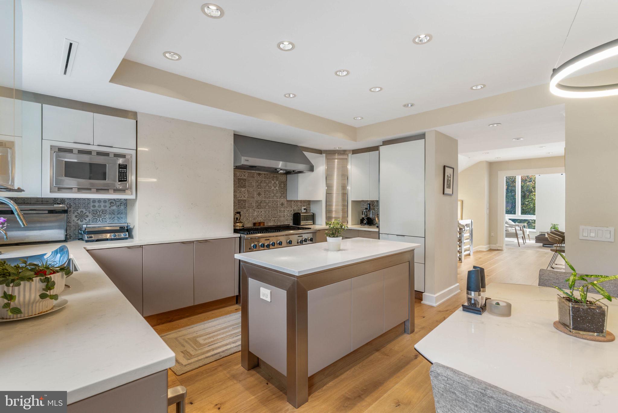 254 South 3rd Street Philadelphia, PA 19106 - Photo 37 of 73 a kitchen with stainless steel appliances granite countertop a stove and a sink