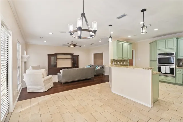 a living room with furniture and kitchen view