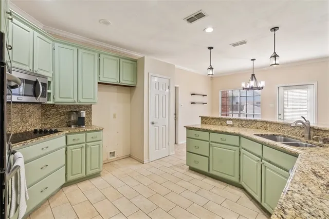 a kitchen with sink and cabinets