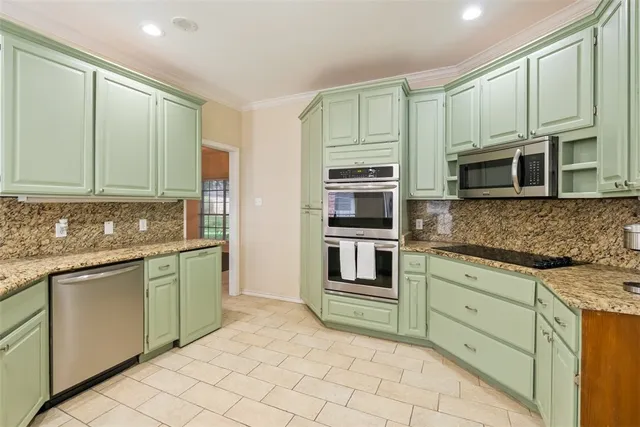 a kitchen with stainless steel appliances a stove sink and cabinets