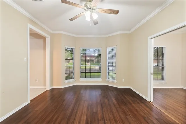 a view of wooden floor and windows in a room