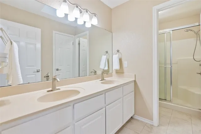 a bathroom with a sink double vanity and shower