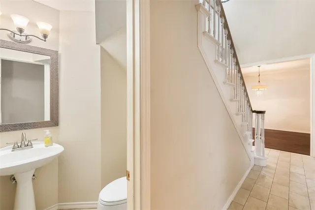 a bathroom with a sink a toilet and a mirror