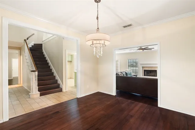 a view of a livingroom with wooden floor and stairs