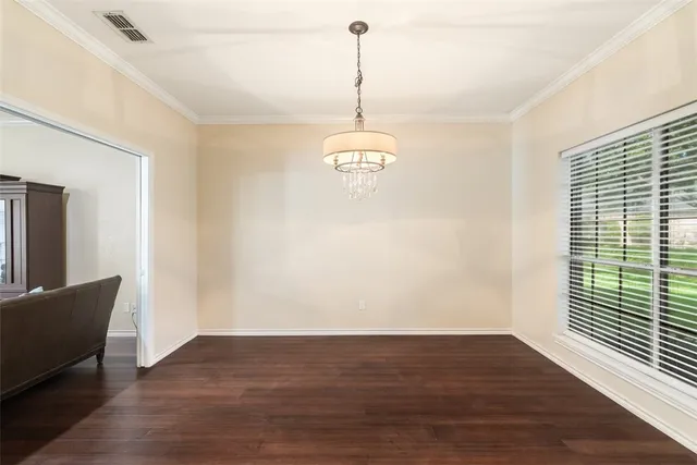 a view of a room with wooden floor windows and a chandelier