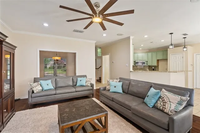 a living room with furniture and a view of kitchen