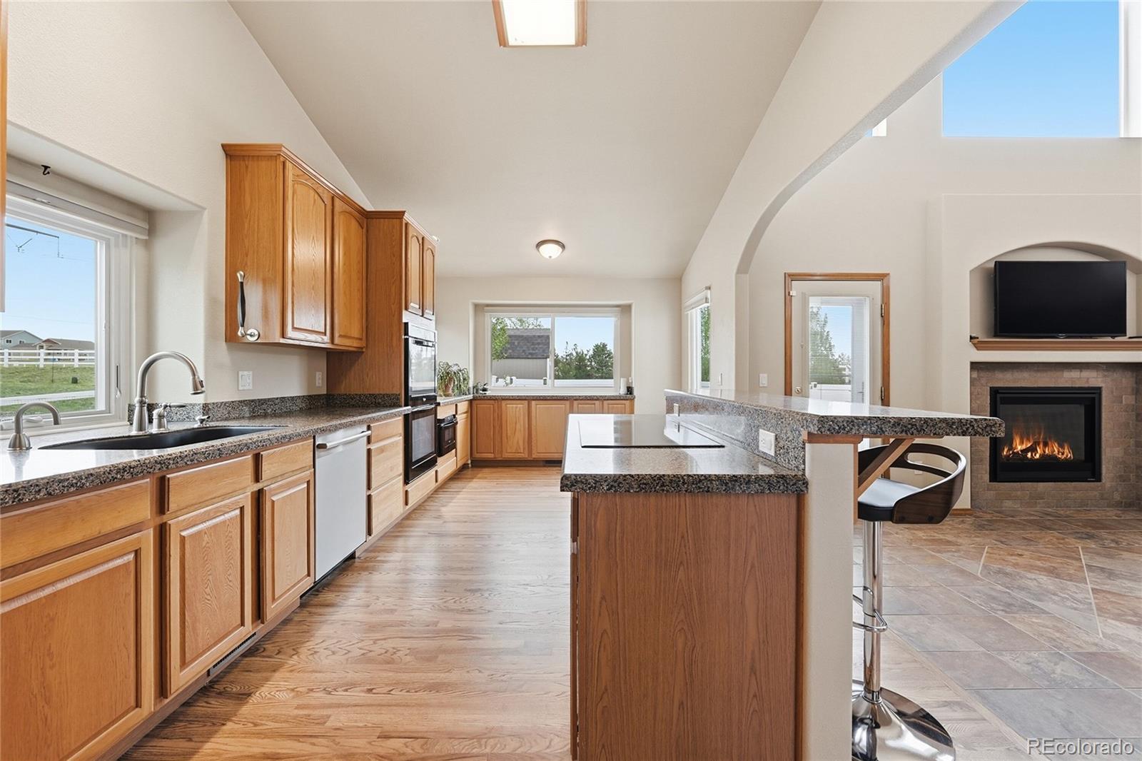 9288 Rockingham Drive Peyton, CO 80831 - Photo 13 of 49 a large kitchen with granite countertop lots of counter top space