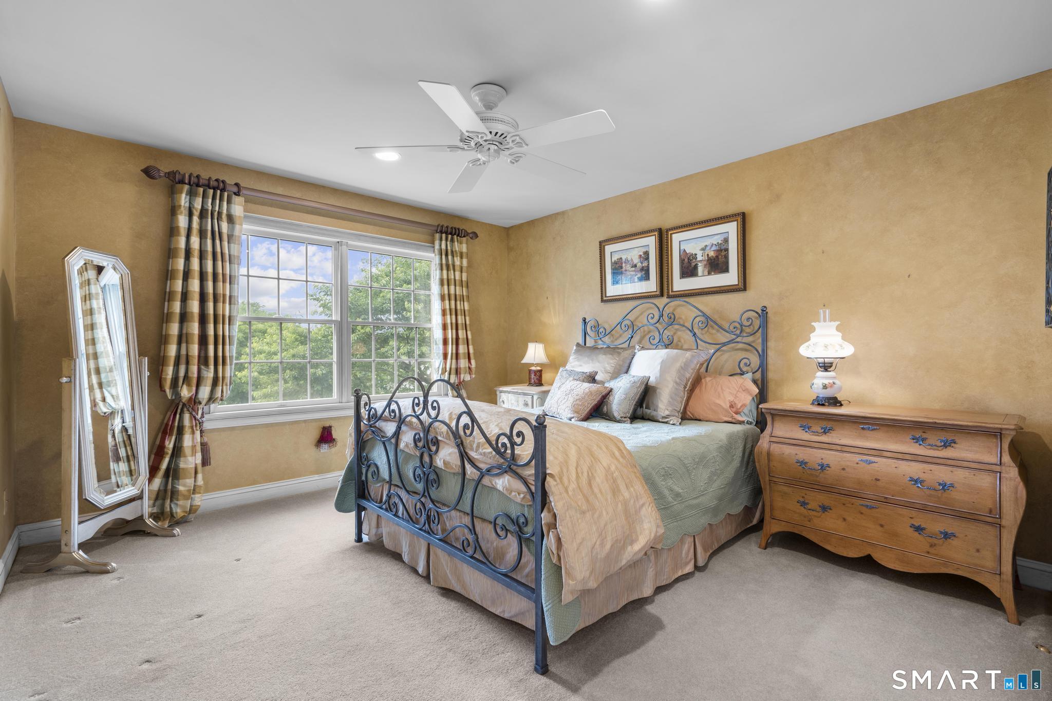 12 Logans Way Danbury, CT 06811 - Photo 28 of 40 a bed room with a bed and a chandelier