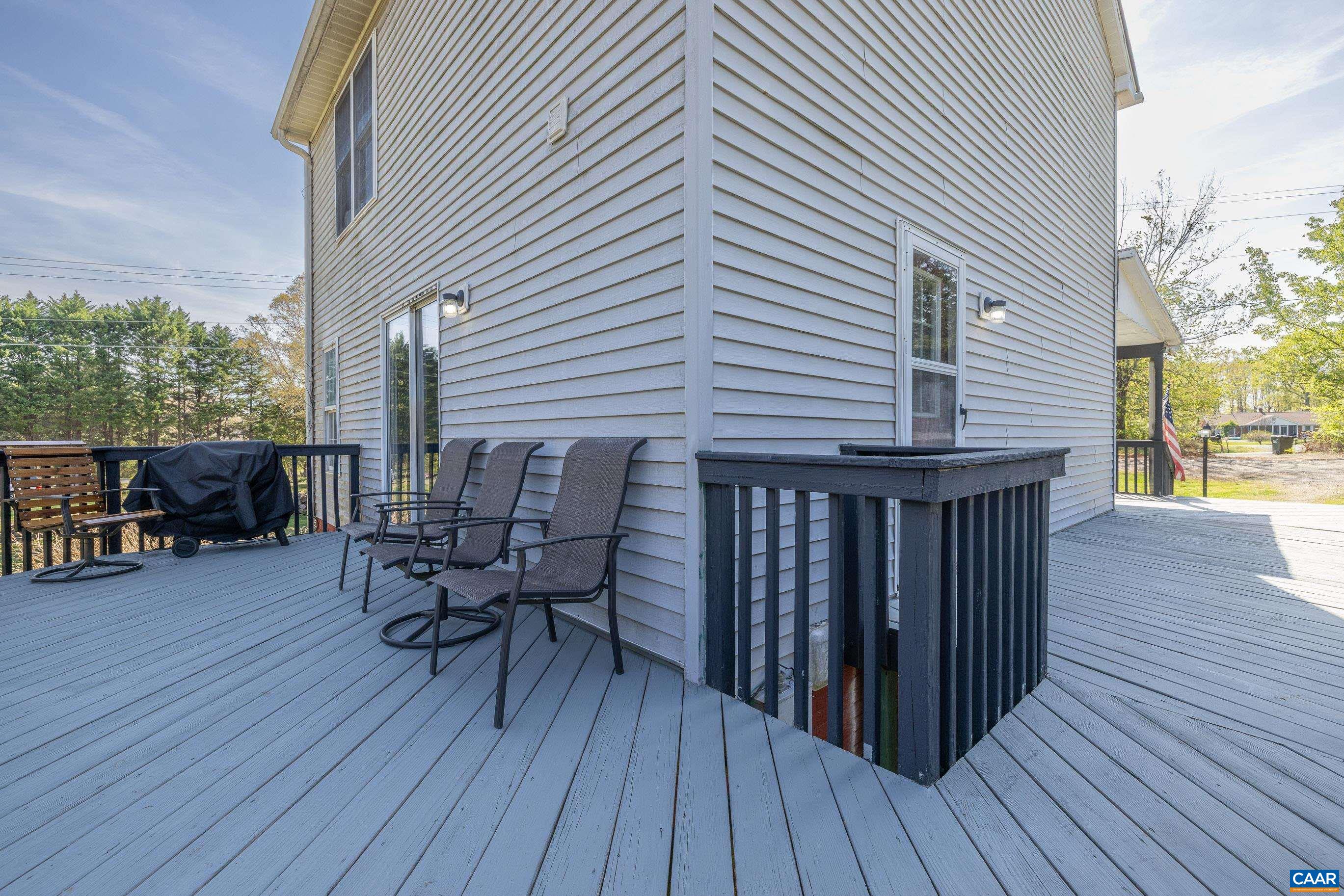6183 Spring Hill Road Ruckersville, VA 22968 - Photo 14 of 31 a view of a roof deck with table and chairs and wooden floor