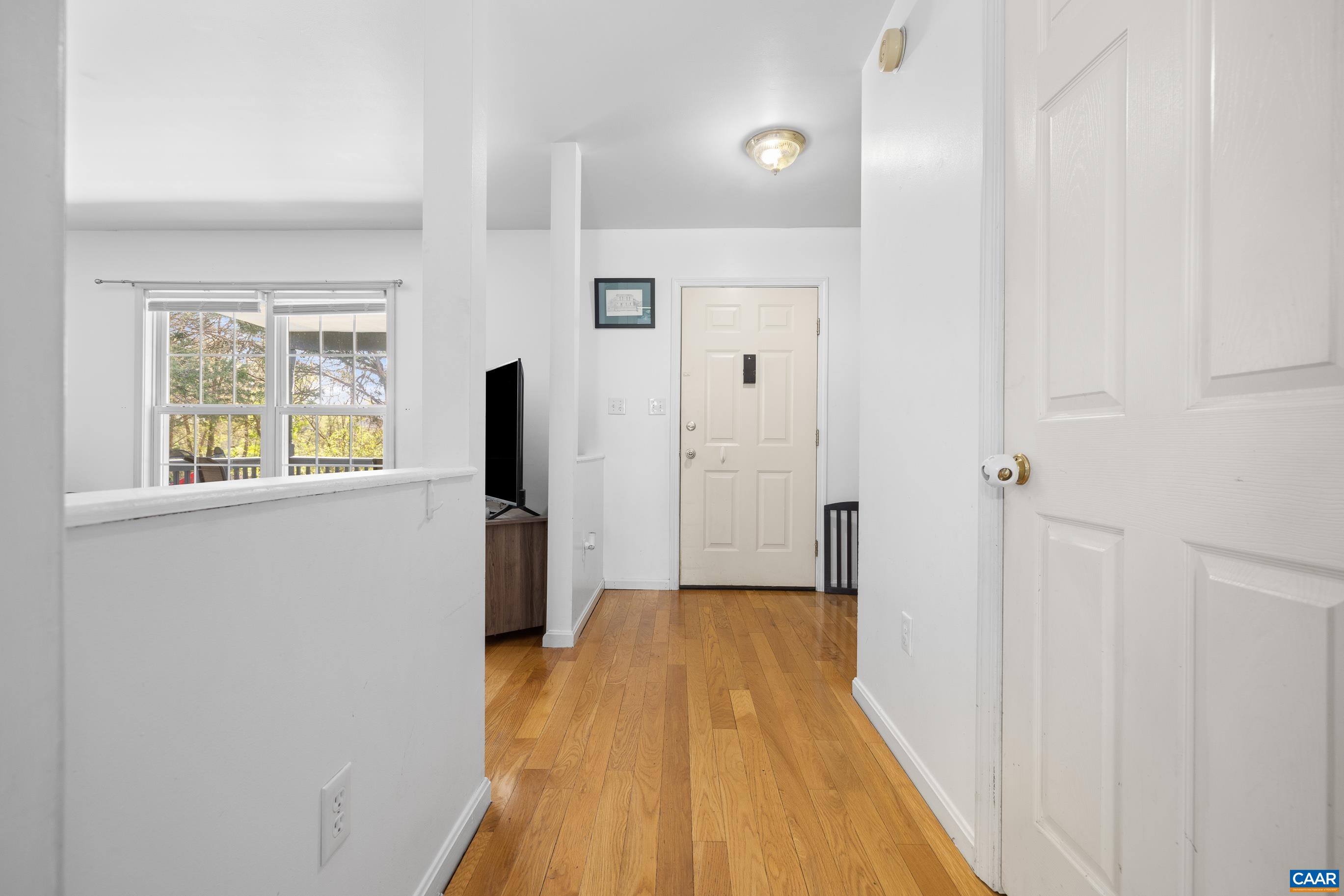 6183 Spring Hill Road Ruckersville, VA 22968 - Photo 18 of 31 a view of a hallway with wooden floor and closet