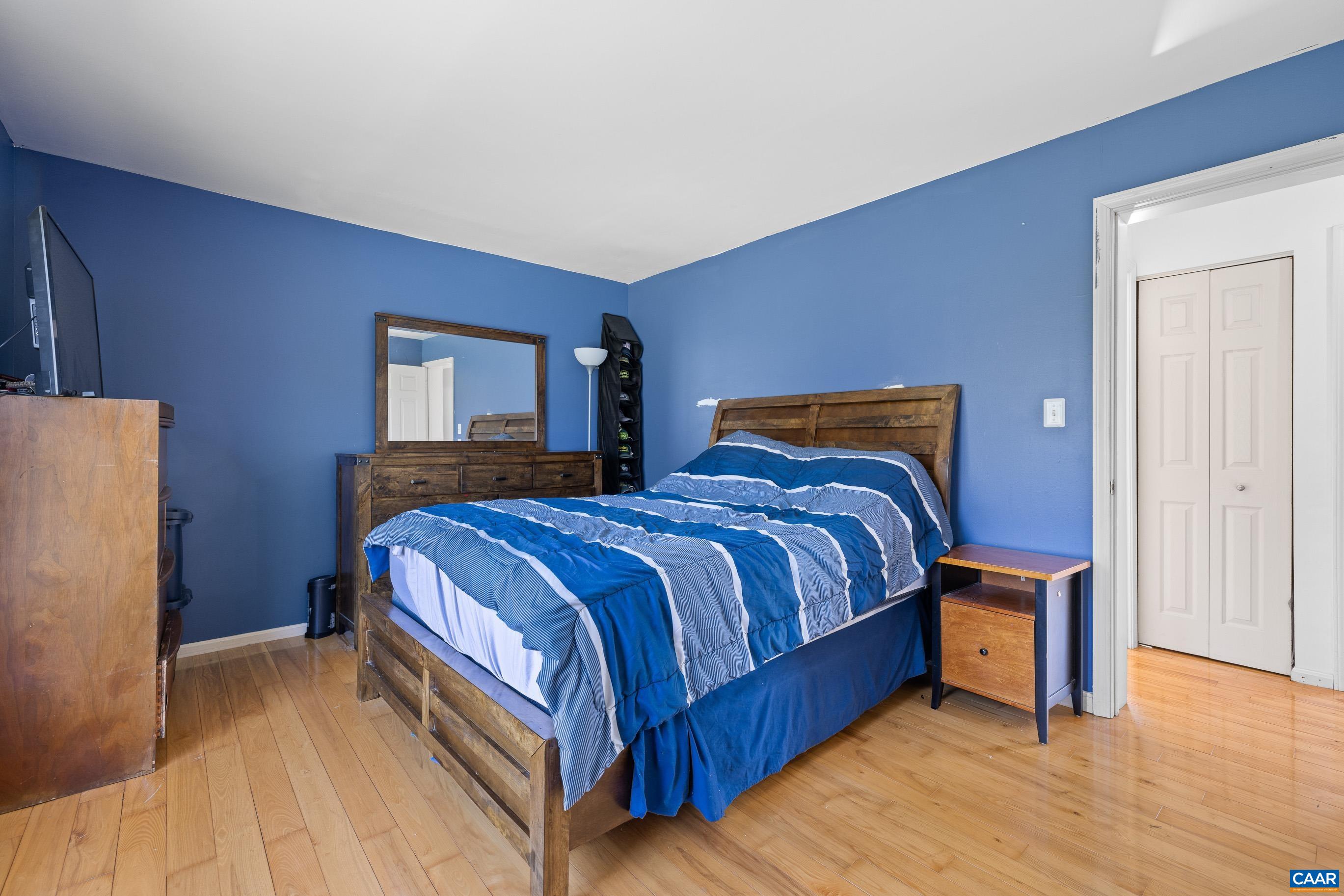6183 Spring Hill Road Ruckersville, VA 22968 - Photo 25 of 31 a bedroom with a bed and a refrigerator