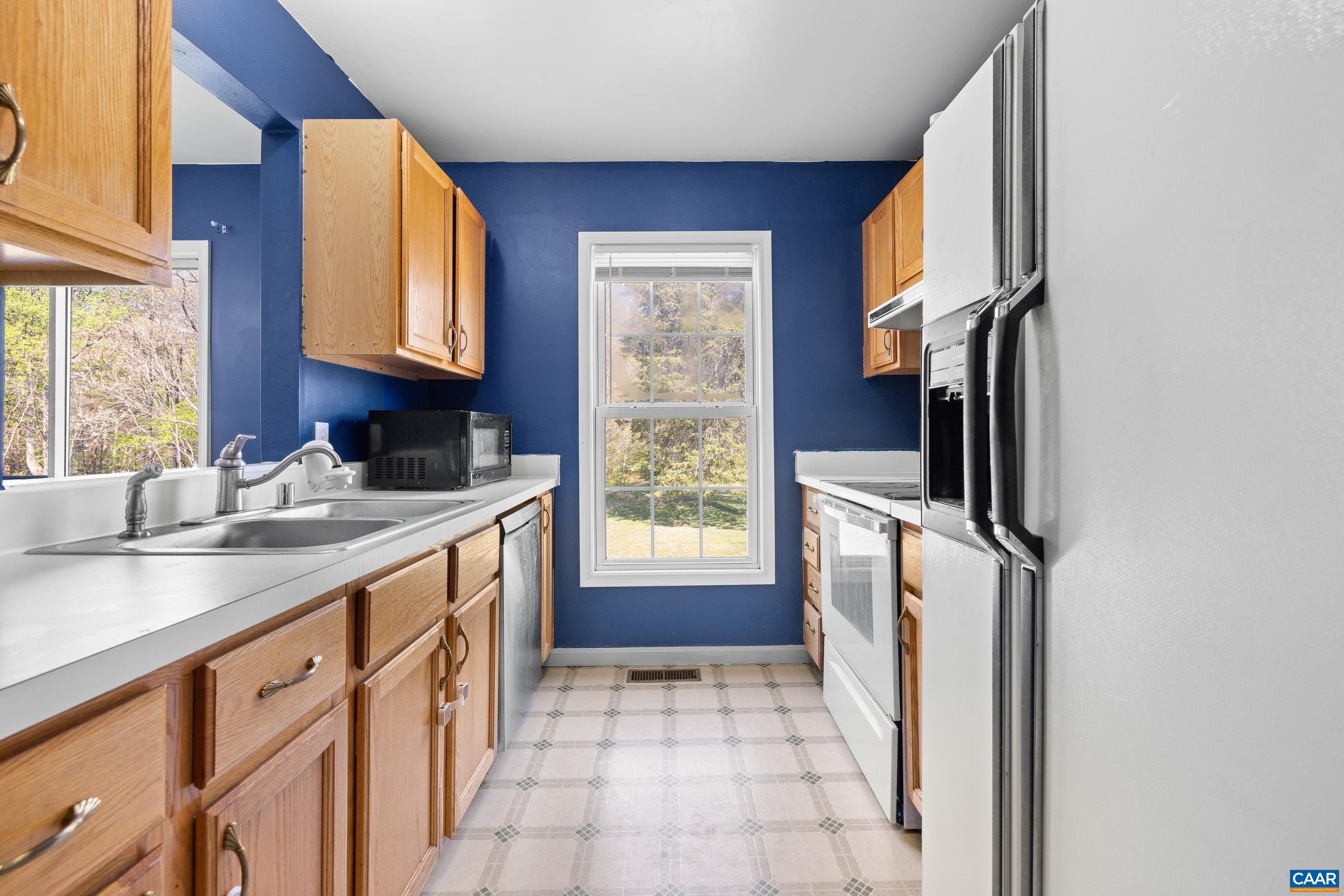 6183 Spring Hill Road Ruckersville, VA 22968 - Photo 6 of 31 a kitchen with stainless steel appliances granite countertop a refrigerator and a sink