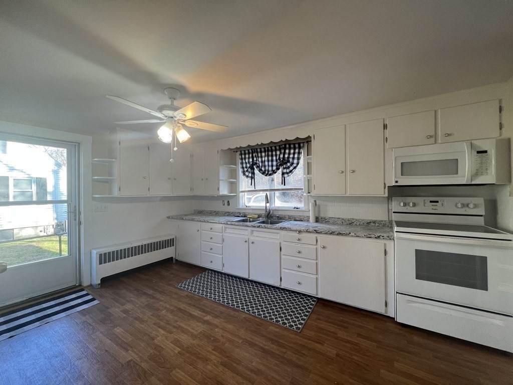 52 Chestnut Street Rehoboth, MA 02769 - Photo 4 of 16 a kitchen with granite countertop white cabinets and white appliances