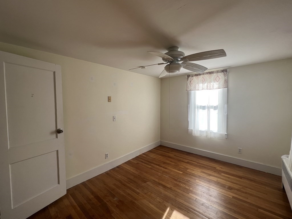 52 Chestnut Street Rehoboth, MA 02769 - Photo 10 of 16 a view of an empty room with a window and wooden floor
