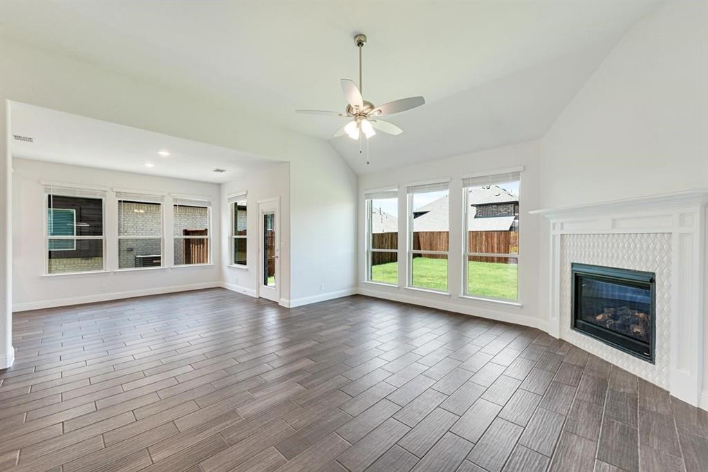 2133 Devonblue Drive Forney, TX 75126 - Photo 10 of 34 a view of an empty room with window and wooden floor