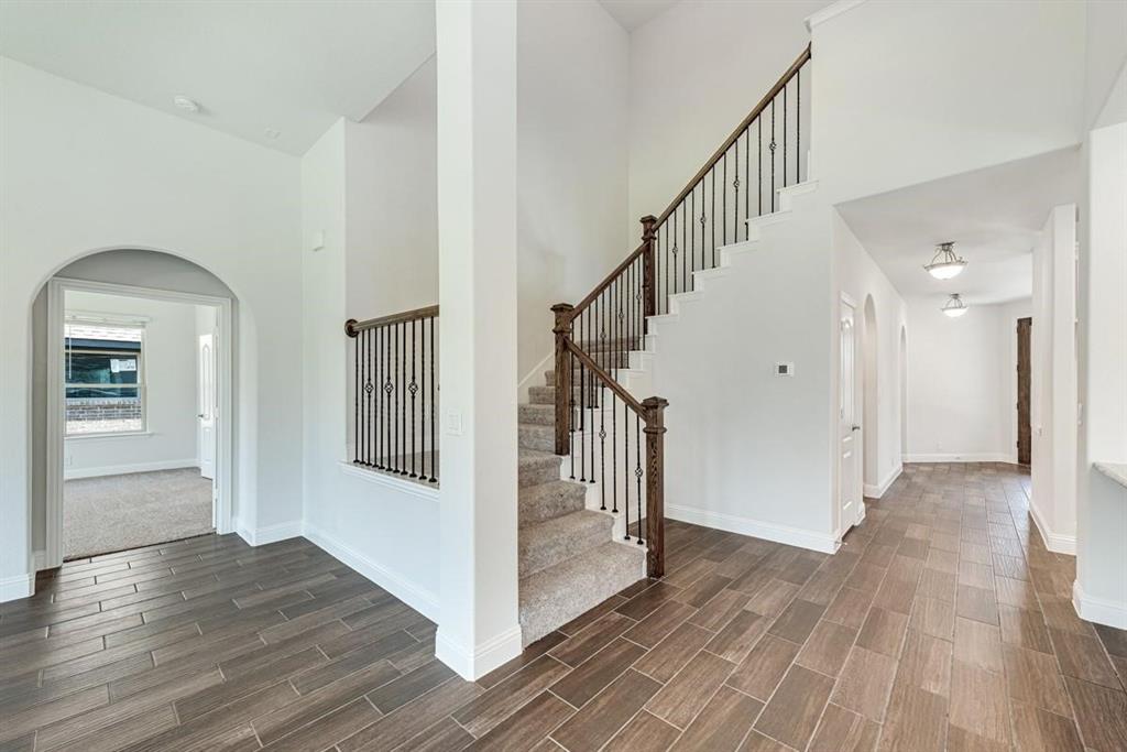 2133 Devonblue Drive Forney, TX 75126 - Photo 12 of 34 a view of a hallway view with wooden floor and staircase