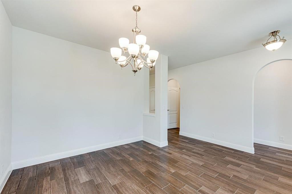 2133 Devonblue Drive Forney, TX 75126 - Photo 14 of 34 a view of a room with wooden floor and chandelier