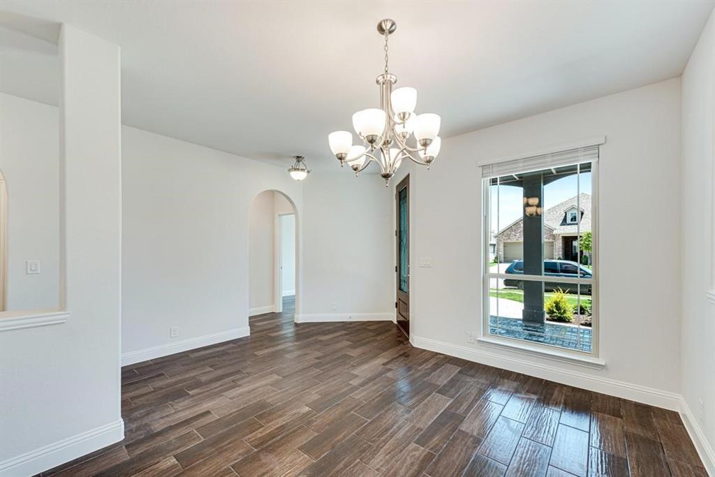 2133 Devonblue Drive Forney, TX 75126 - Photo 15 of 34 a view of a room with wooden floor and chandelier