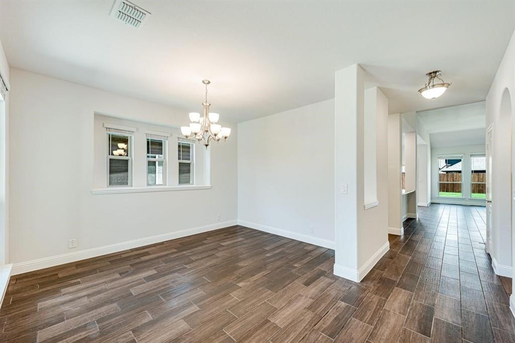 2133 Devonblue Drive Forney, TX 75126 - Photo 16 of 34 a view of livingroom with hardwood floor and kitchen