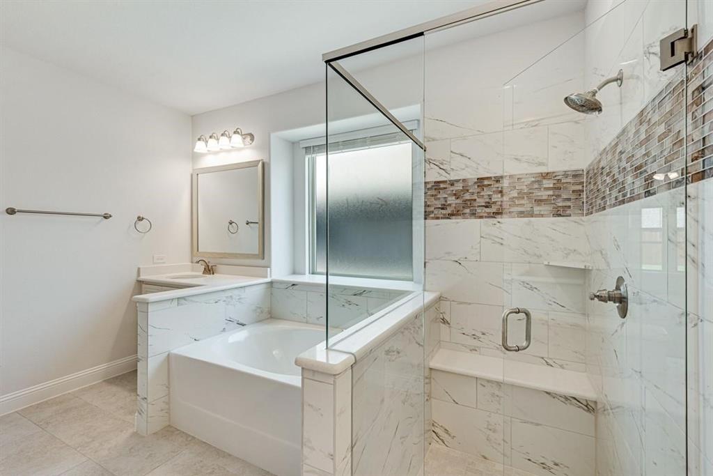 2133 Devonblue Drive Forney, TX 75126 - Photo 21 of 34 a bathroom with a granite countertop sink a mirror and shower