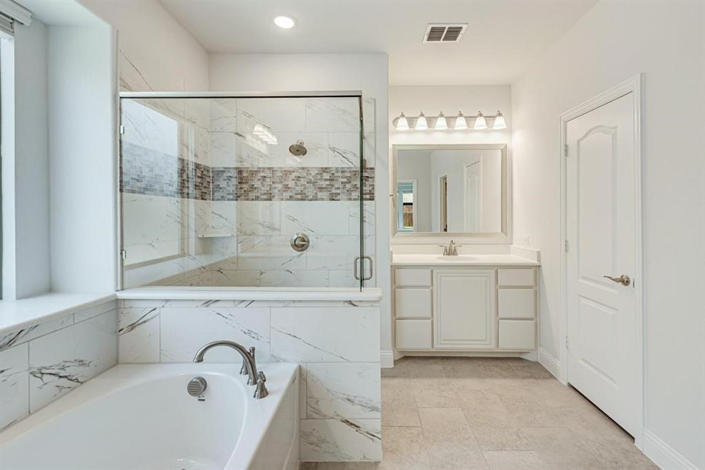 2133 Devonblue Drive Forney, TX 75126 - Photo 22 of 34 a bathroom with a tub sink and mirror