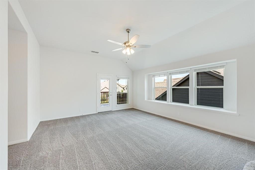 2133 Devonblue Drive Forney, TX 75126 - Photo 23 of 34 an empty room with chandelier fan and windows