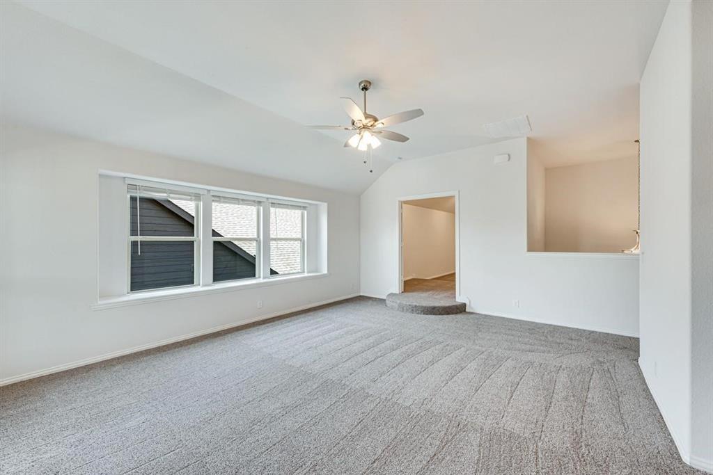 2133 Devonblue Drive Forney, TX 75126 - Photo 26 of 34 a view of an empty room with a window and a kitchen