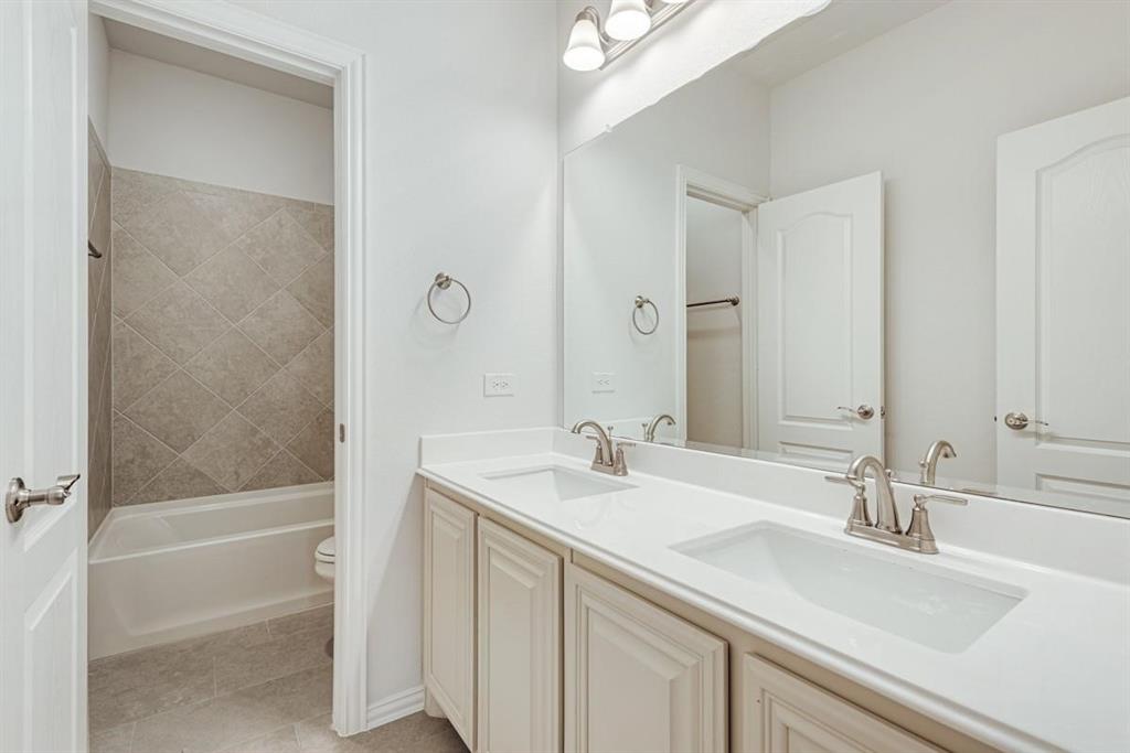 2133 Devonblue Drive Forney, TX 75126 - Photo 28 of 34 a bathroom with a sink and a mirror