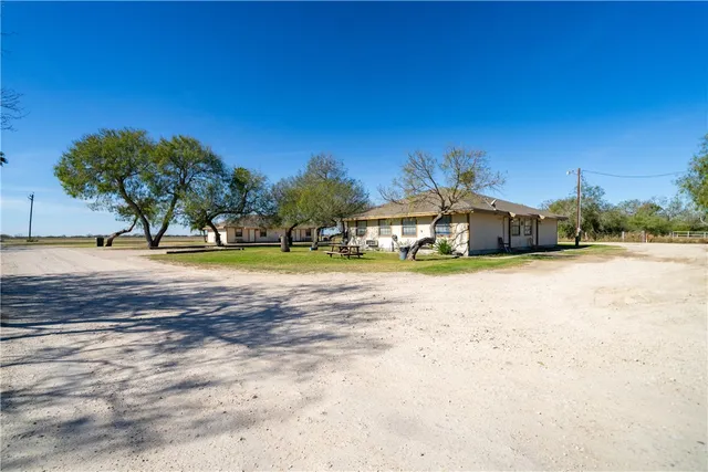a view of a house with a yard and sitting area