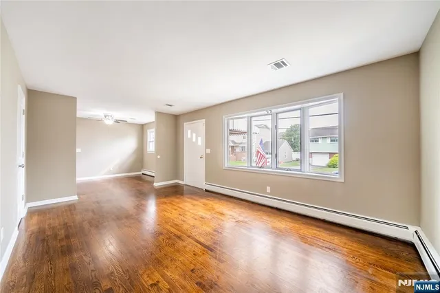 wooden floor in an empty room with a window