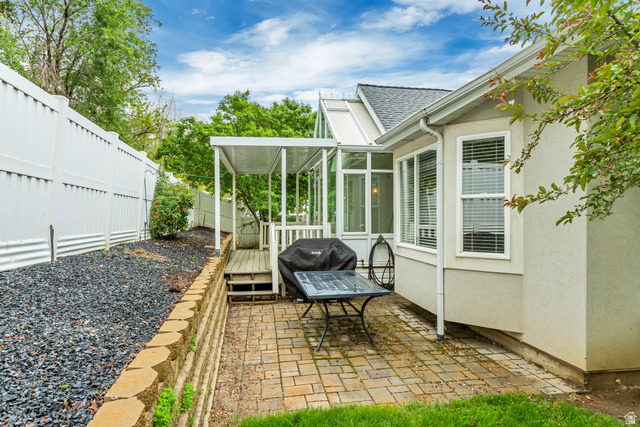 1433 Forge Way Draper, UT 84020 - Photo 28 of 29 Patio area featuring paver flooring, a covered deck, and an adjacent sunroom