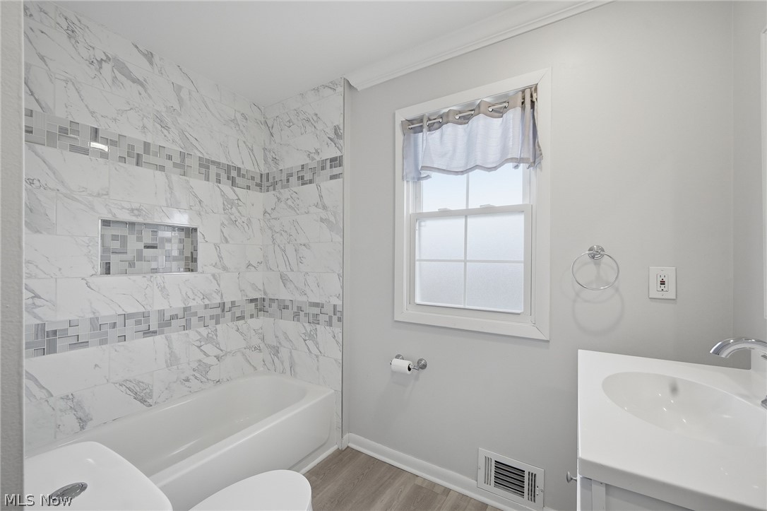 3722 Lindholm Road Shaker Heights, OH 44120 - Photo 23 of 34 The bathroom features a tiled shower and bathtub combination with a decorative mosaic band and an integrated niche