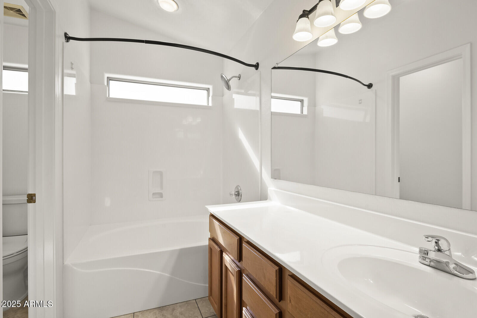 3297 East Warbler Road Gilbert, AZ 85297 - Photo 17 of 32 a bathroom with a sink and a mirror