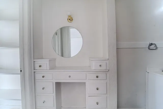 a close view of a dresser and mirror in a room